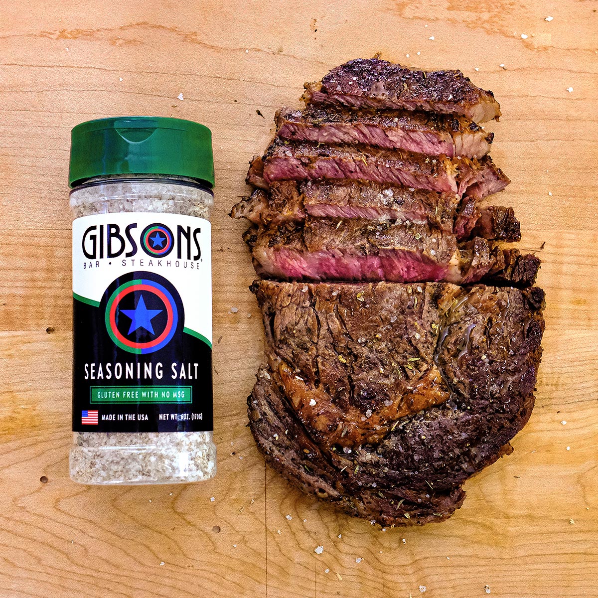Cooked Steak next to a Gibsons Salt Bottle