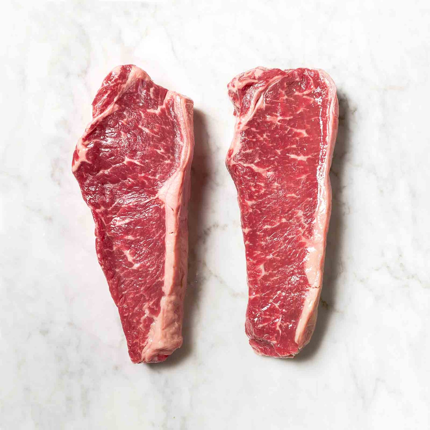 Two Raw New York Strip Steaks