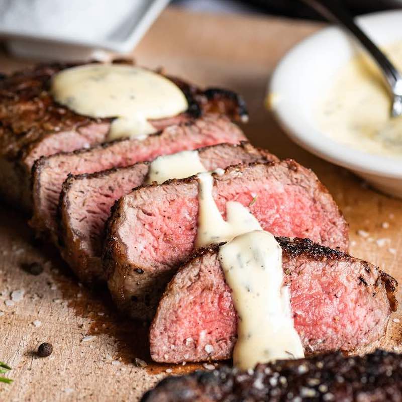 Sliced New York Strips with sauce